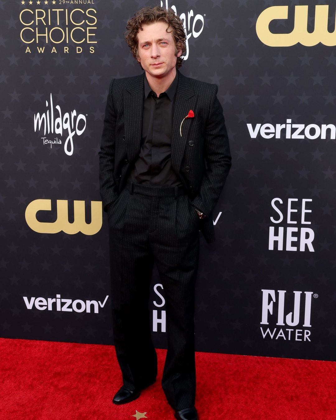The best actor in a comedy series winner for his role in The Bear, Jeremy Allen White looked dapper in a pinstriped black Saint Laurent suit. He accessorized his outfit with a Bulgari red lapel pin, adding a hint of color and contrast to his ensemble. His signature curls and shiny oxfords completed his solid look.