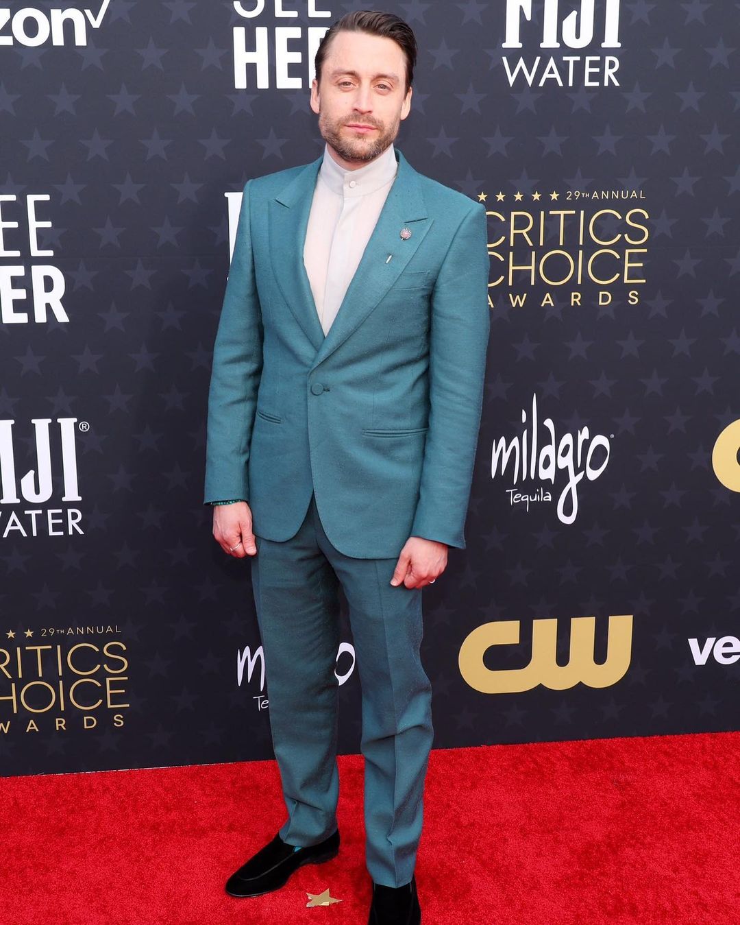 Culkin looked elegant in a light-blue Zegna suit with a classy white shirt with a Chinese collar. The actor accessorized his ensemble with a sophisticated lapel pin and a beaded wrist stack. Kieran Culkin took home TV’s Favorite Dramatic Actor prize for his work in Succession at the prestigious 2024 Critics Choice Awards night.
