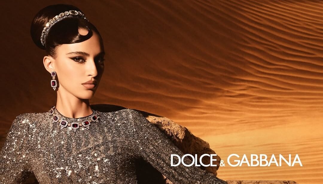 Amira Al-Zuhair in silver gown on desert dunes