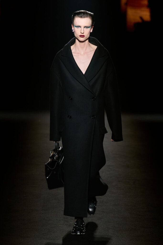 A menswear look featuring Euphoria season three graphics on a long wool coat.